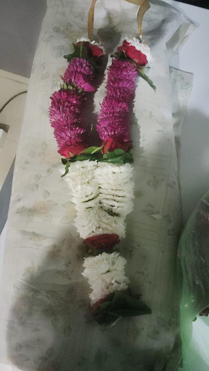 Magenta celosia and white flower mala finished with rosebuds
